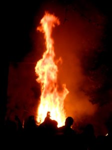 A bonfire at Greek Easter in a Cretan mountain village at night, with flames reaching up to the height of 3 to 4 people.